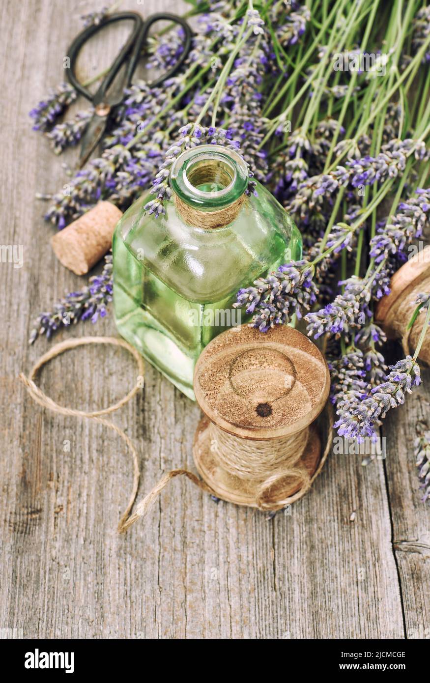 Lavender flowers and herbal oil bottle rustic vintage wooden background Stock Photo