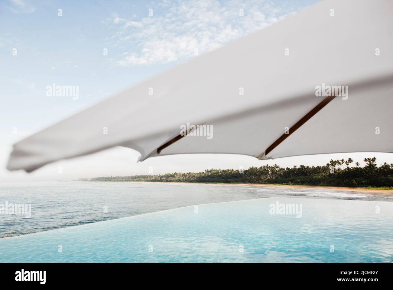 The main ocean-view infinity pool at a resort. Aturuwella, Bentota, Sri Lanka. Stock Photo