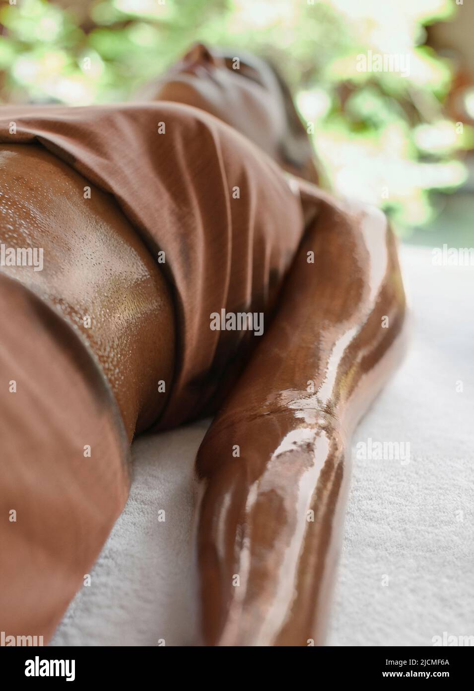 A woman receives Dark Chocolate massage and skin treatment at a spa in Sri Lanka. Stock Photo