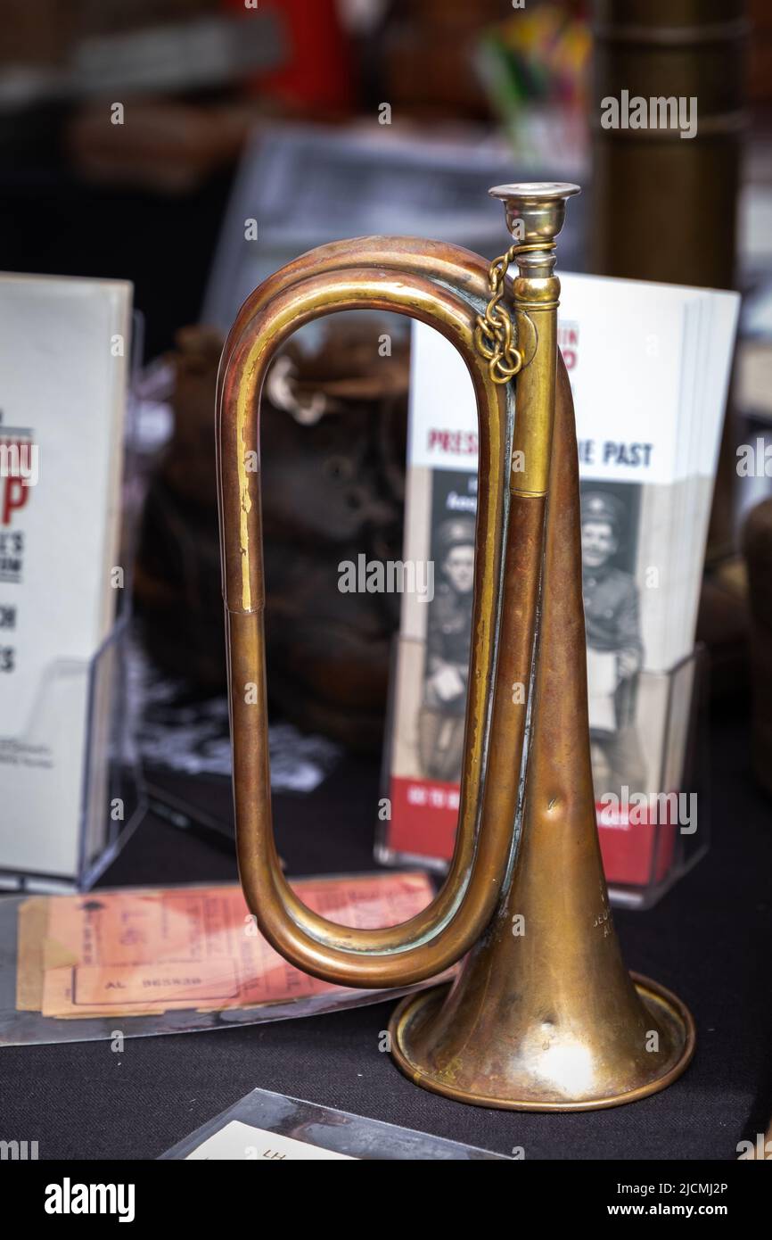 Old and battered brass bugle as part of the Army support display by the Royal British Legion stand at the Royal Cornwall Show. Old but still used. Stock Photo
