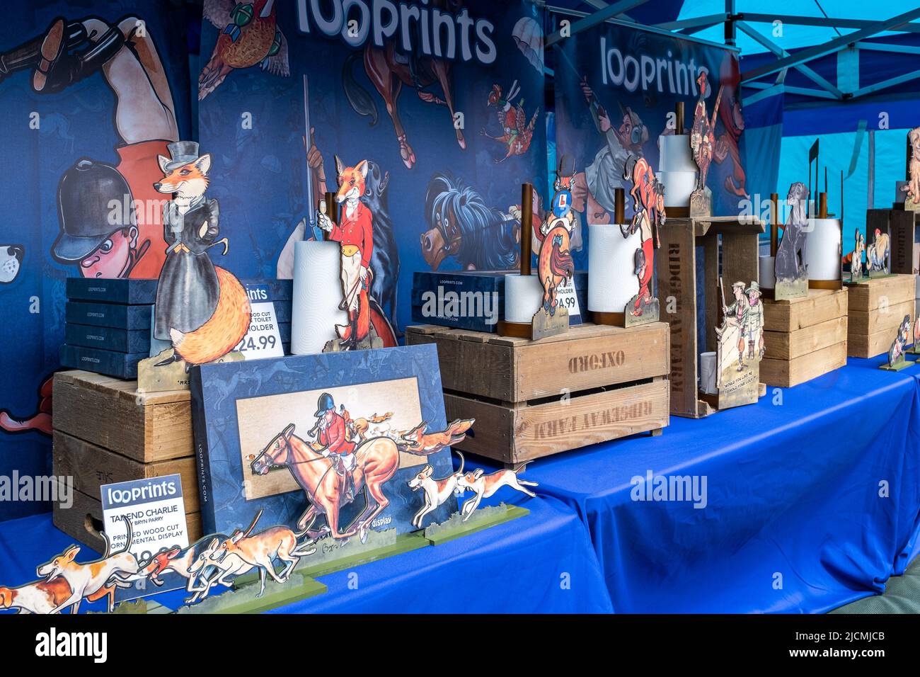 Great display of Thelwell style pony loo roll holders and toilet seat covers for sale at the Royal Cornwall show. Colourful, cheerful and funny. Stock Photo