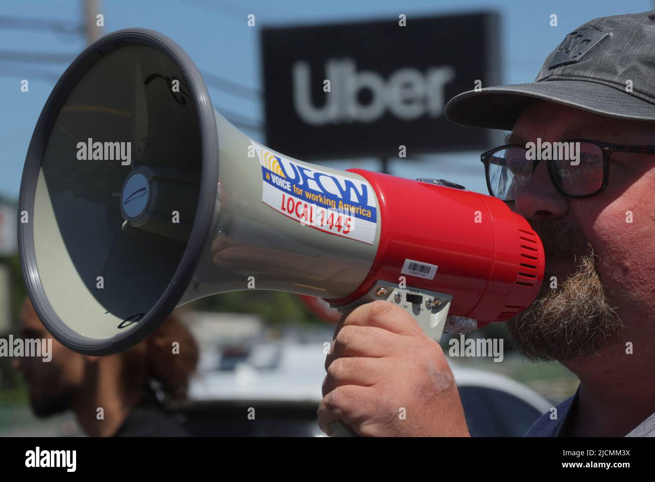 Multi-app delivery driver Kevin Murphy speaks during a protest against Uber's elimination of fuel surcharges for drivers amid high gas prices, in Saugus, Massachusetts, U.S. June 14, 2022. REUTERS/Brian Snyder Stock Photo