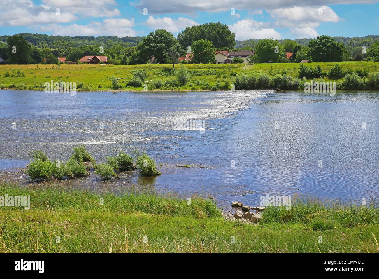 View from belgian border over river Maas rapids for rafting on dutch riverfront, idyllic rural landscape - Maasvallei, Limburg, Netherlands and Belgiu Stock Photo