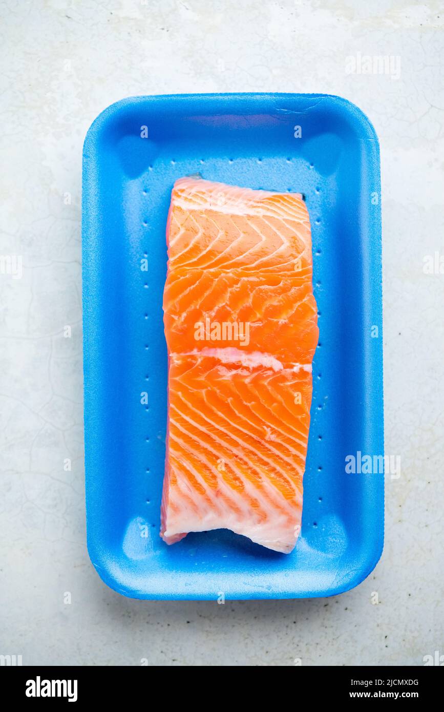 Fresh raw salmon in plastic container, close up view. Stock Photo