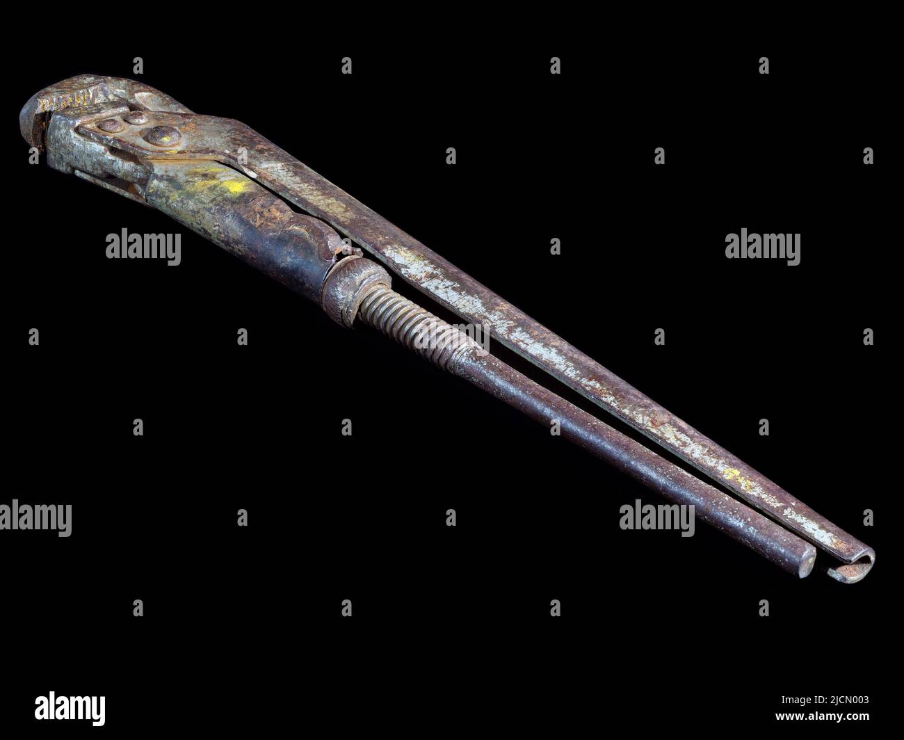 Old rusty adjustable wrench isolated on black background Stock Photo