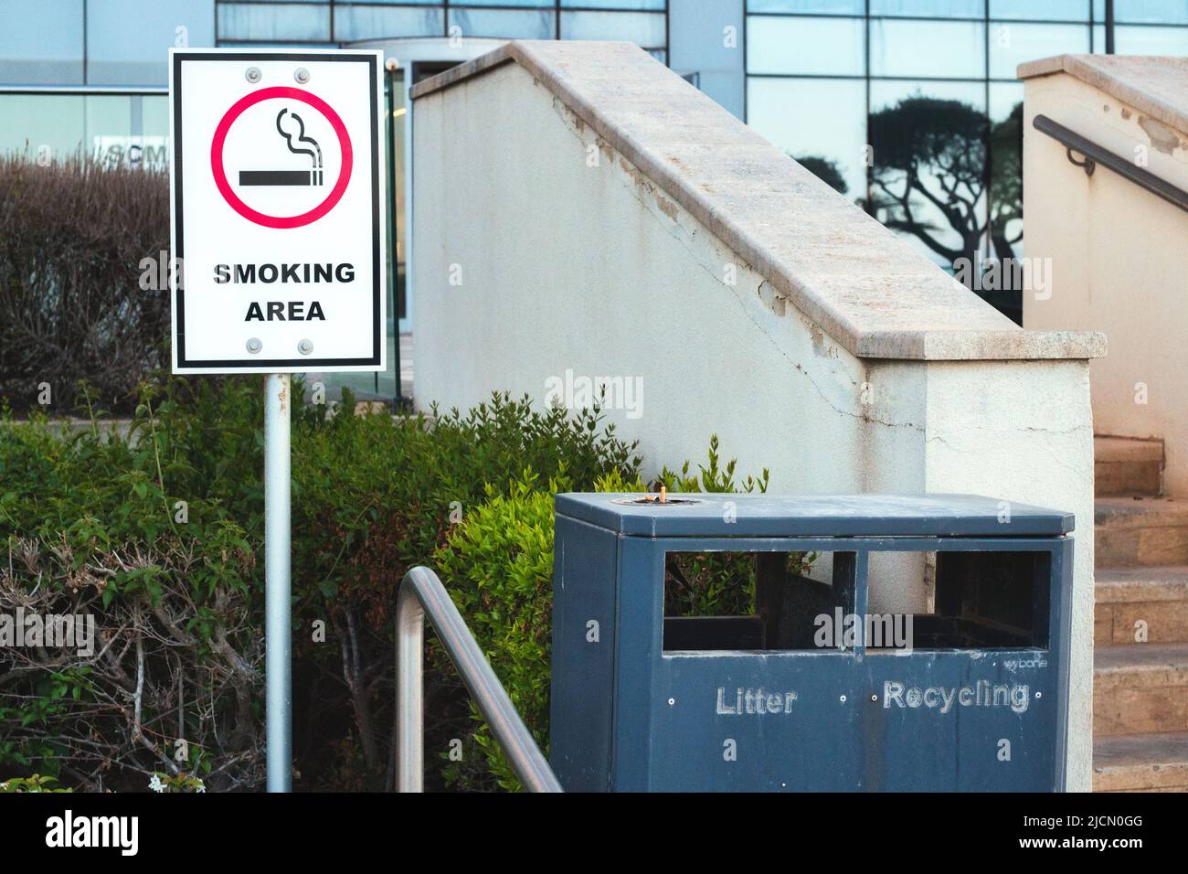 A designated outdoor smoking area outside an office block Stock Photo