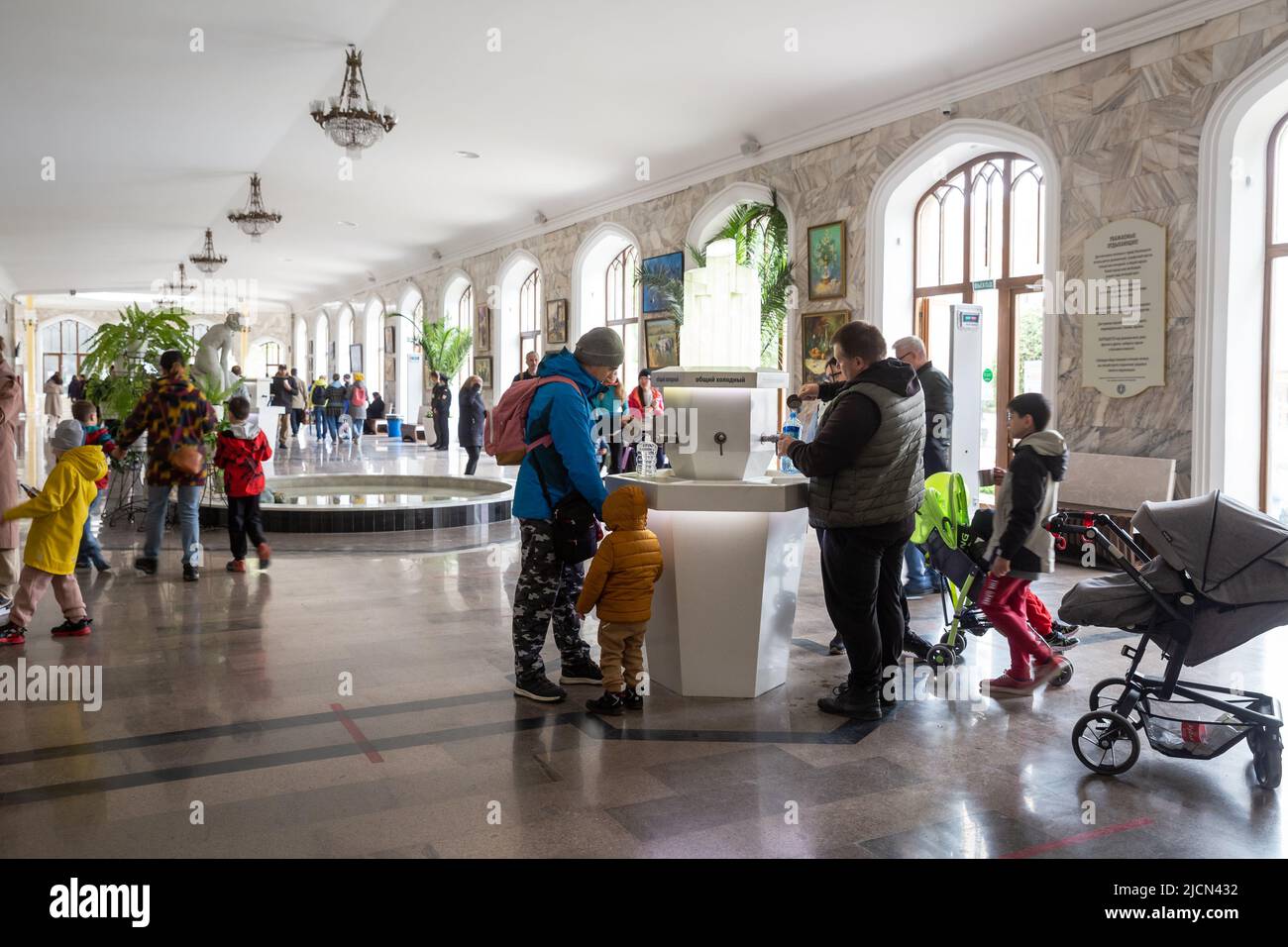 Kislovodsk, Russia - May 08, 2022: Kislovodsk Narzan Gallery, many people drink healthy mineral water and pour it into bottles Stock Photo