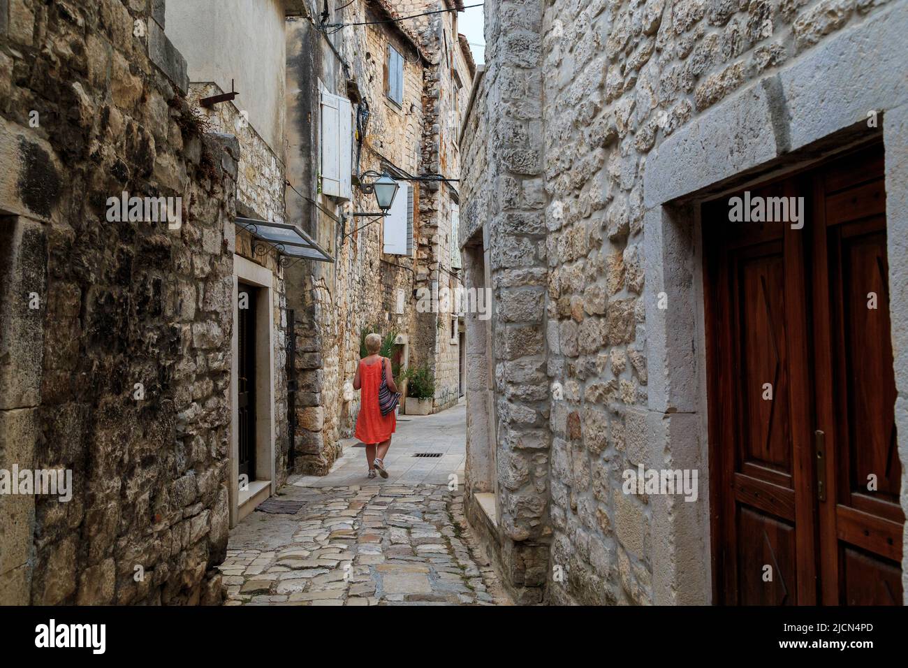TROGIR, CROATIA - SEPTEMBER 11, 2016: This is one of the alleys of the old historic part of the small Croatian seaside town, which is wholly inscribed Stock Photo