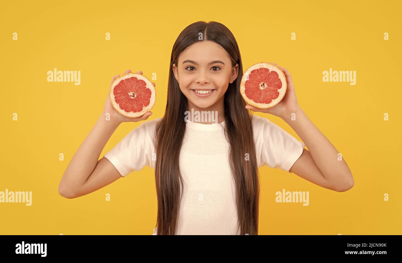 diet and kid skin beauty. positive teen girl with grapefruit. vitamin and dieting. Stock Photo