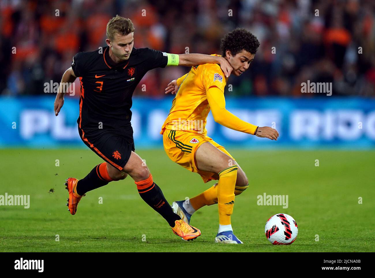 Netherlands Matthijs de Ligt and Wales Brennan Johnson (right) battle for the ball during the UEFA Nations League match at the Stadion Feijenoord, Rotterdam. Picture date: Tuesday June 14, 2022. Stock Photo