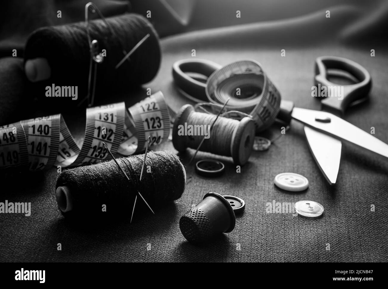 Retro tools for cutting and sewing. Needle with thread, thimble, sewing