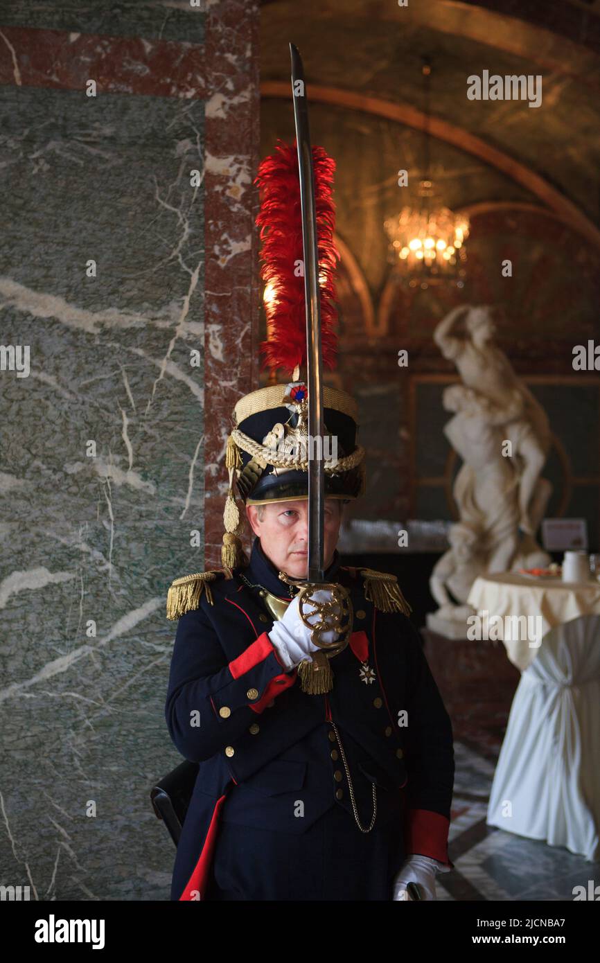 A French officer presenting his sabre in salute at the historical reenactment of the Duchess of Richmond's ball (15 June 1815) in Brussels, Belgium Stock Photo