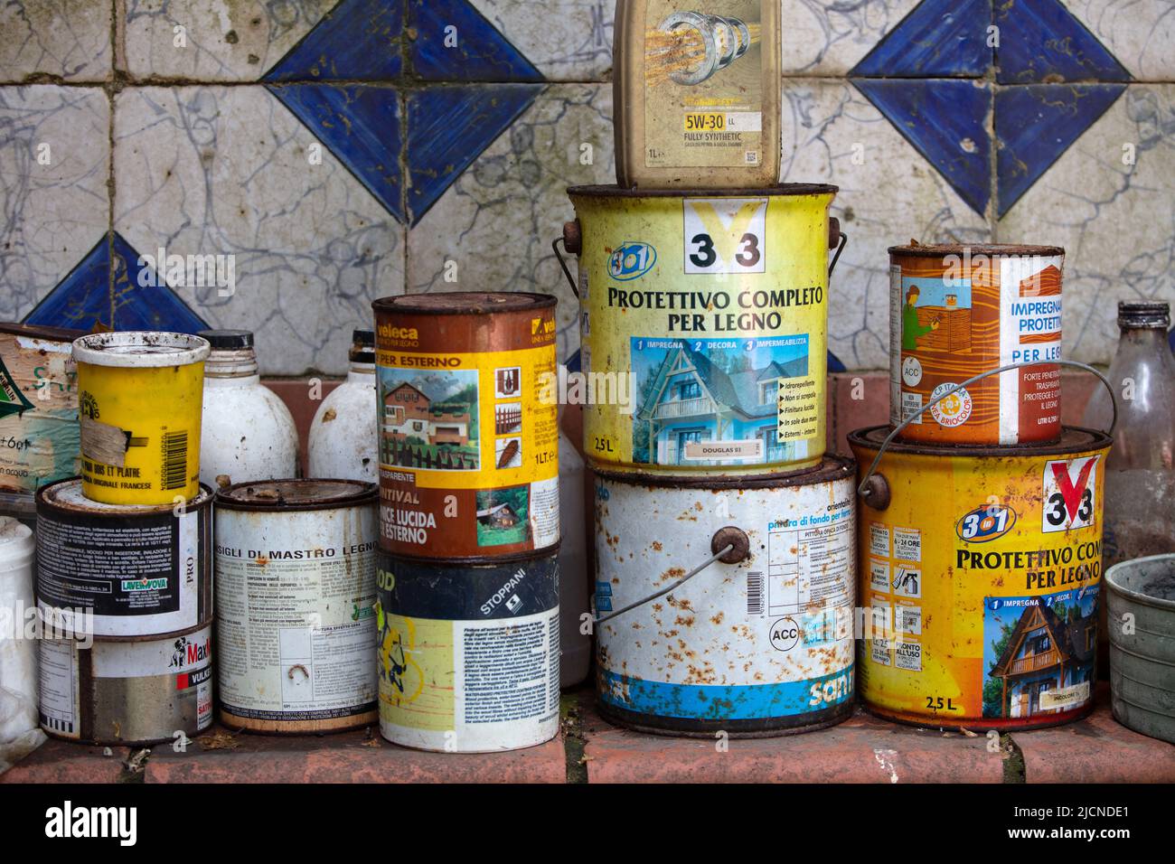 an amazingly beautiful and colourful photograph of tin cans against a tiled wall Stock Photo