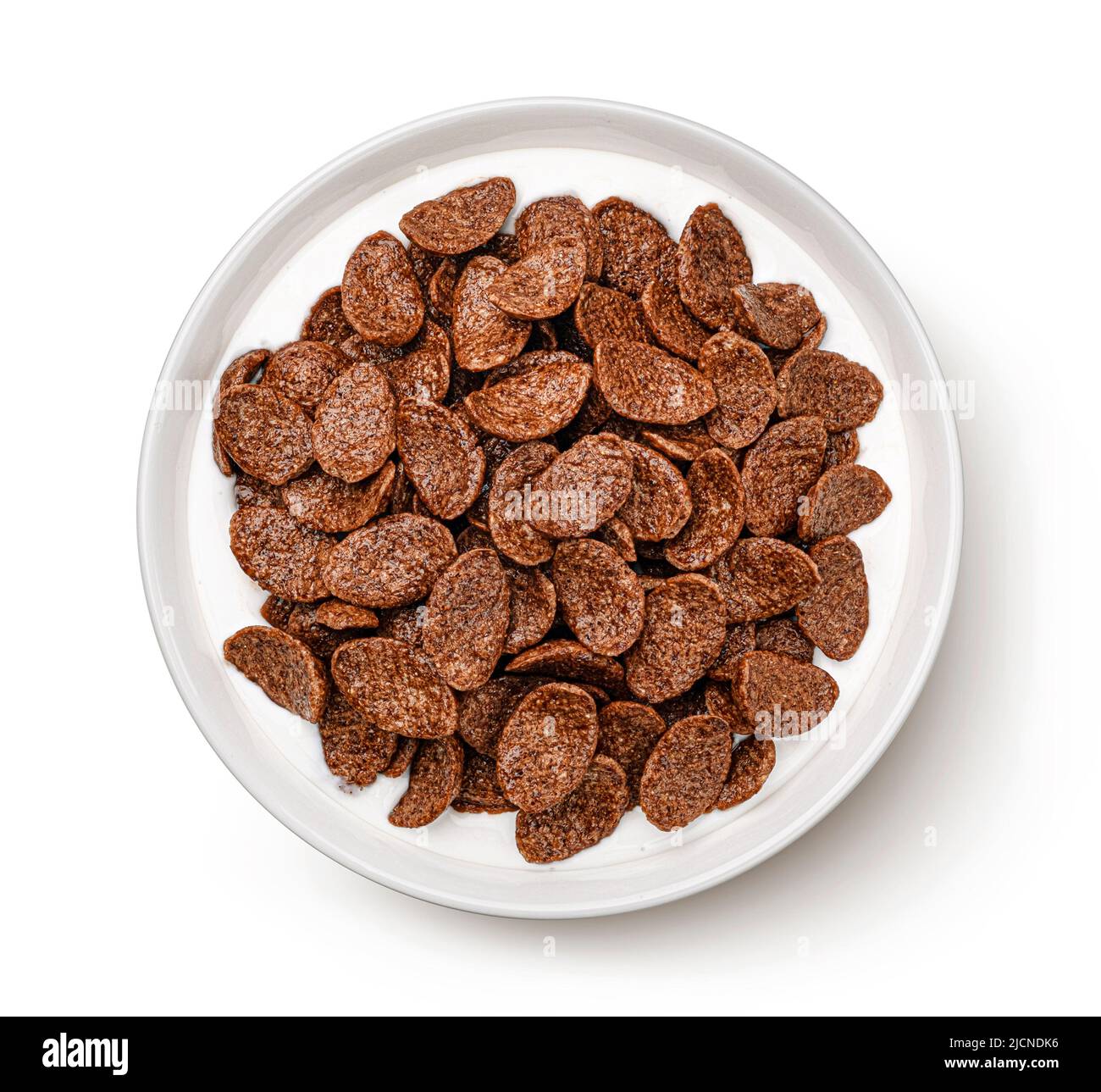 Chocolate corn flakes with milk isolated on white, top view Stock Photo