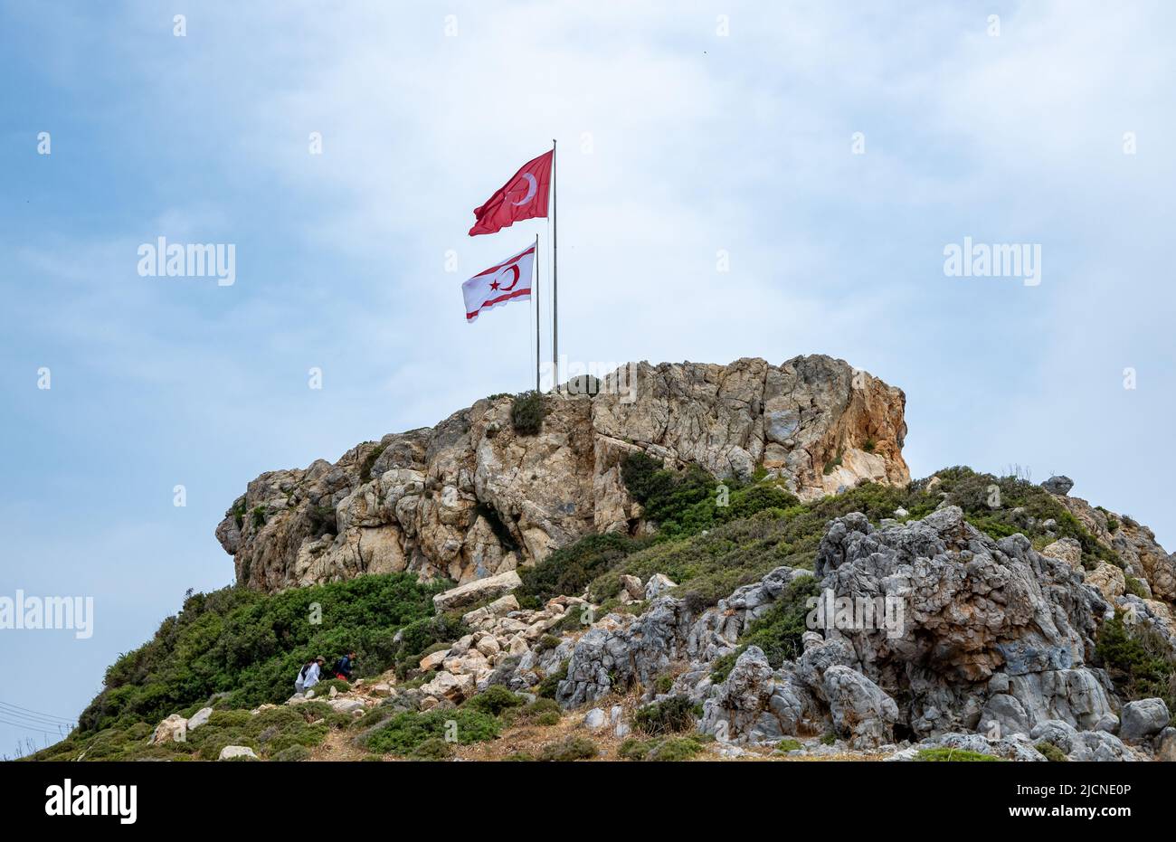 Turkish and Turkish Cyprus flags flying on the flagpole at the Cape Apostolos Andreas, eastern tip of the Cyprus island. Cyprus. Stock Photo