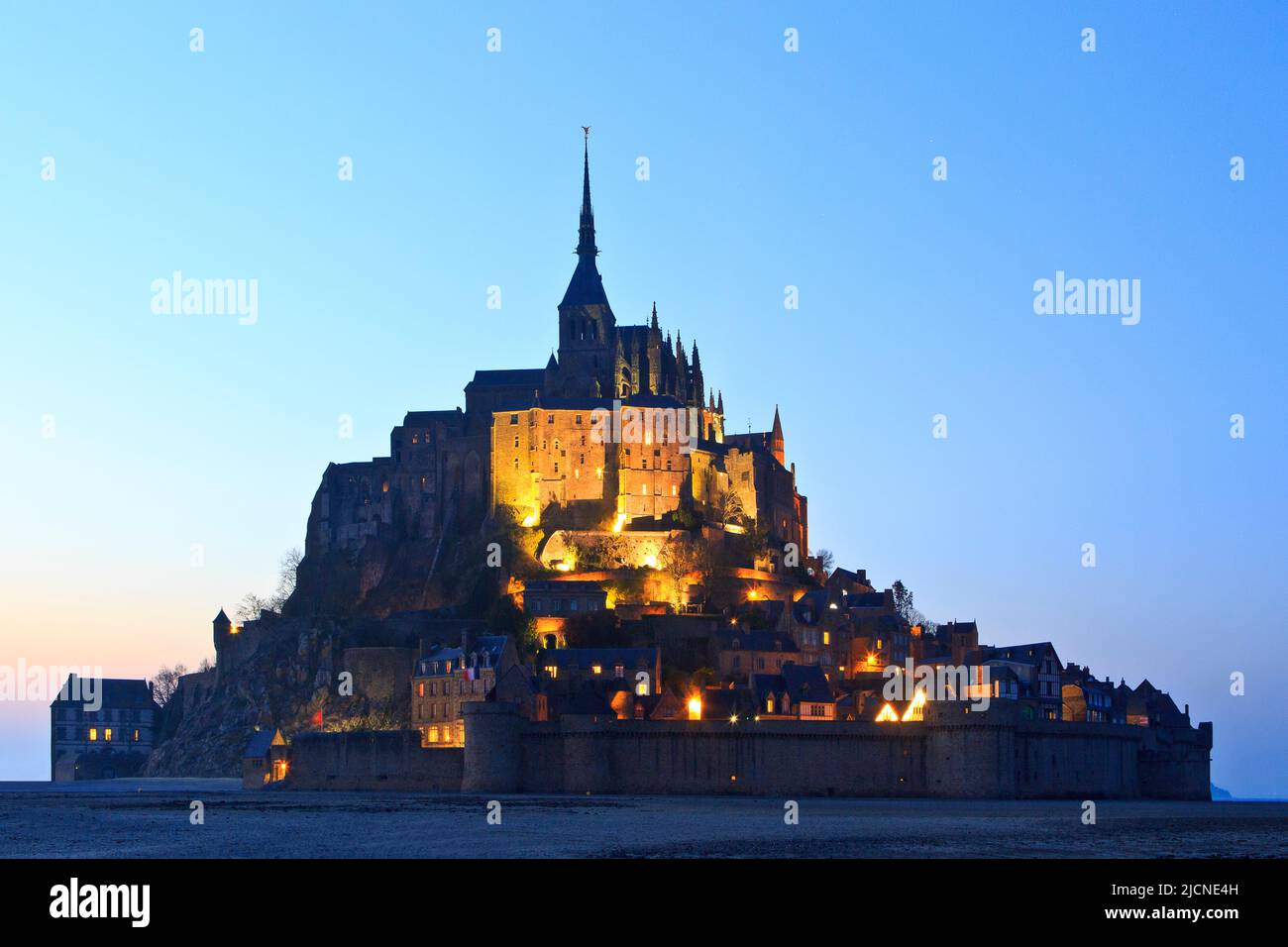 The Mont-Saint-Michel (Saint Michael's Mount), a medieval Christian tidal islet and UNESCO World Heritage Site at twilight in Normandy, France Stock Photo