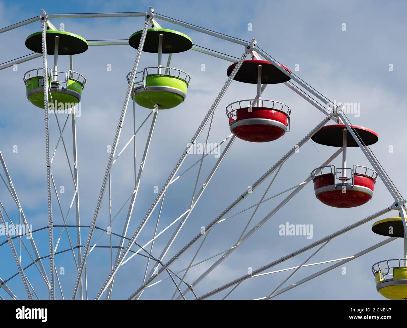 Carousel Ferris wheel with colorful cabins. Fun fair attractions. A ...