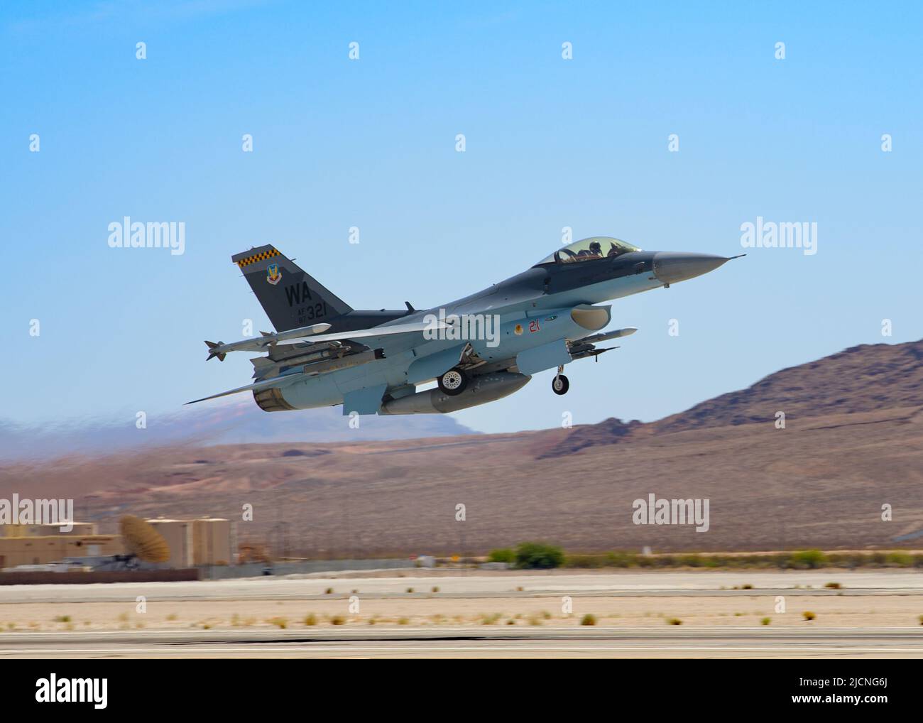 An F-16 Fighting Falcon assigned to the 64th Aggressor Squadron takes off for a routine training mission at Nellis Air Force Base, Nevada, May 17, 2022. The 64th AGRS operates 30 F-16C/M aircraft, providing realistic, threat-representative, opposing forces for high-end US and coalition training. (U.S. Air National Guard photo by Staff Sgt. Adam Welch) Stock Photo