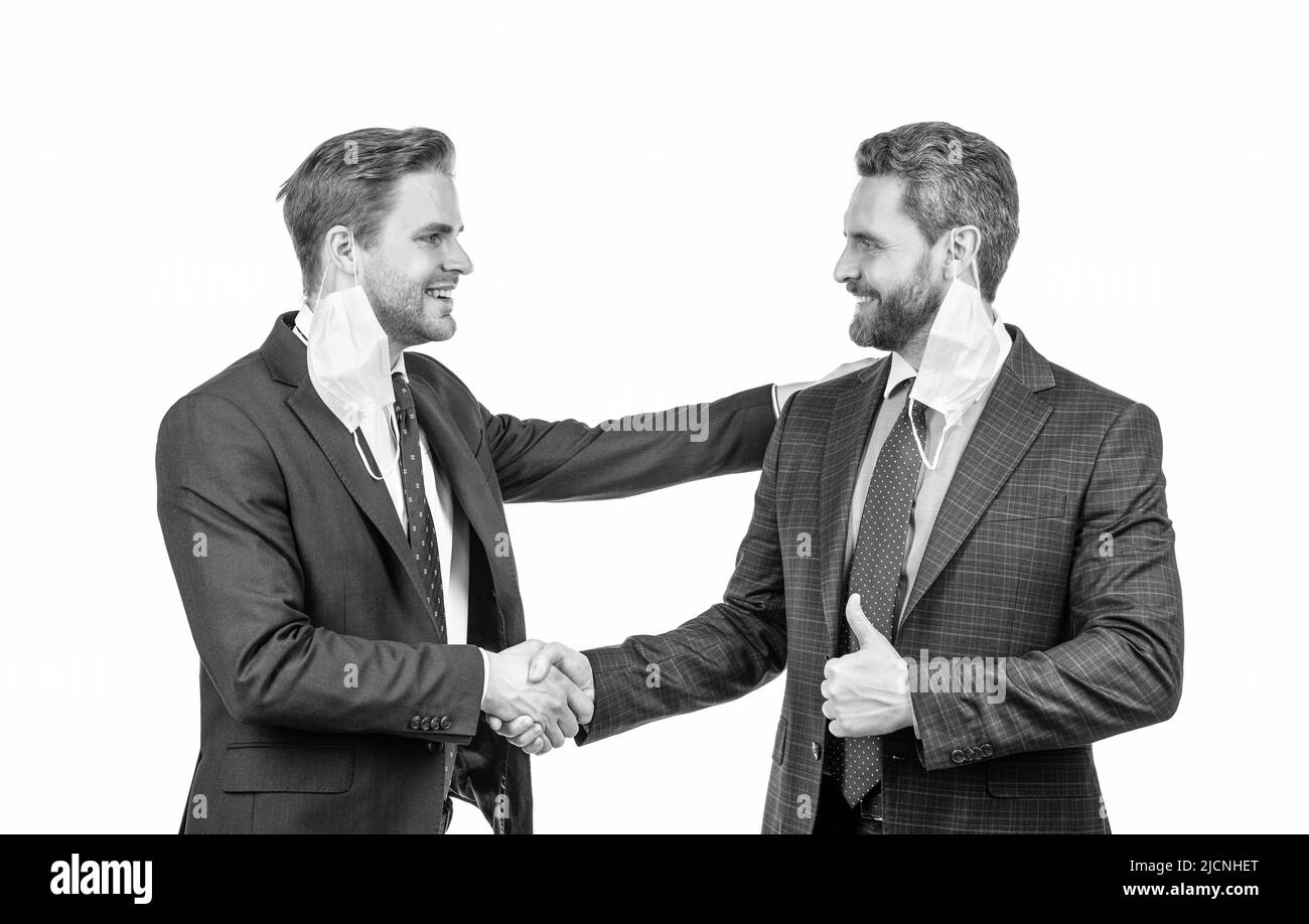 two men in mask shaking hands. businessmen on meeting. healthcare concept. Stock Photo