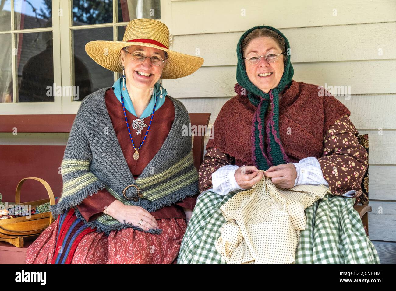 two women wearing authentic replica clothes from the 1850's at Fort Nisqually in Tacoma, Washington Stock Photo