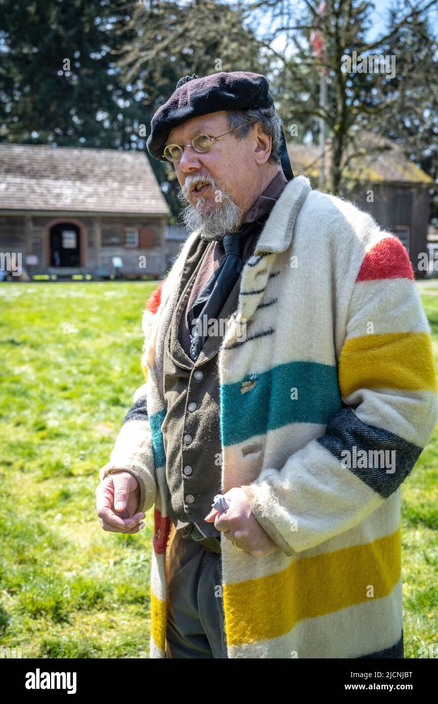 guide and reenactment volunteer wearing a coat that would have been worn by men at the Hudson Bay Company in Fort Nisqually, Tacoma, Washington Stock Photo