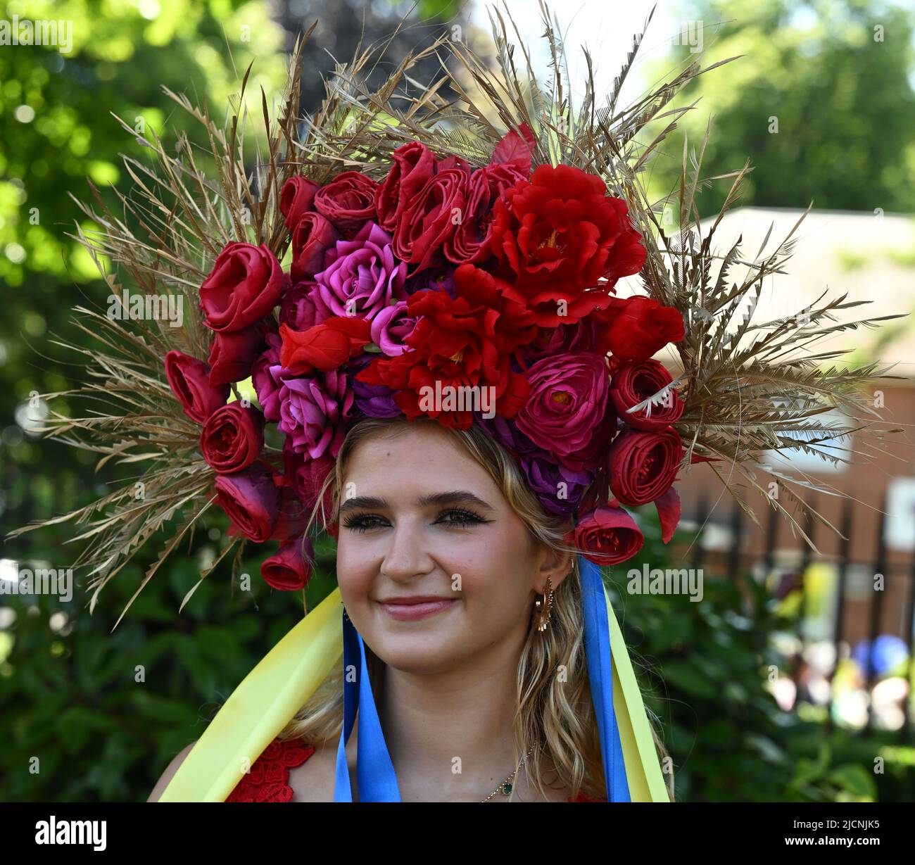 Ascot, UK. 14 June, 2022.  A racegoer wears a scarf in the colours of the Ukraine flag during the first day of Royal Ascot 2022 in Ascot, England. Credit: Anwar Hussein Credit: Anwar Hussein/Alamy Live News Stock Photo