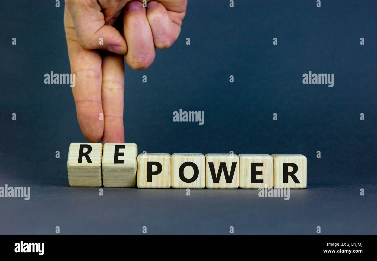 Power or repower symbol. Businessman turns wooden cubes and changes concept words Power to Repower. Beautiful grey table grey background. Business eco Stock Photo