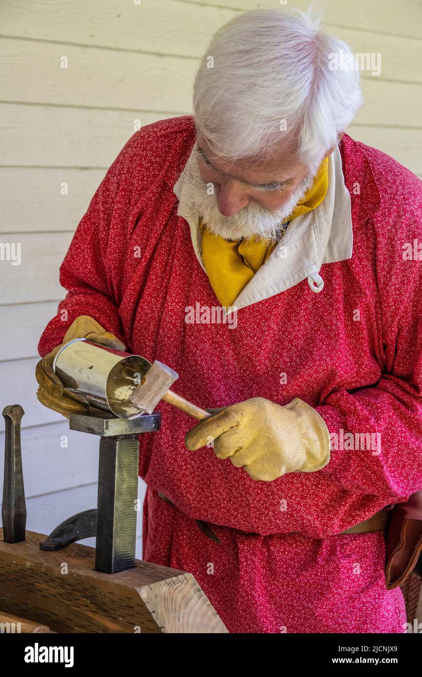 reenactment historian volunteer working with tin Stock Photo