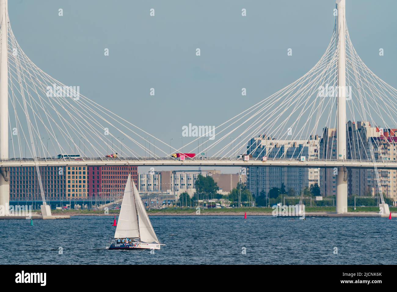 Russia, St. Petersburg, 10 June 2022: Sailing boats in the background of the new cable stayed bridge in sunny day Stock Photo