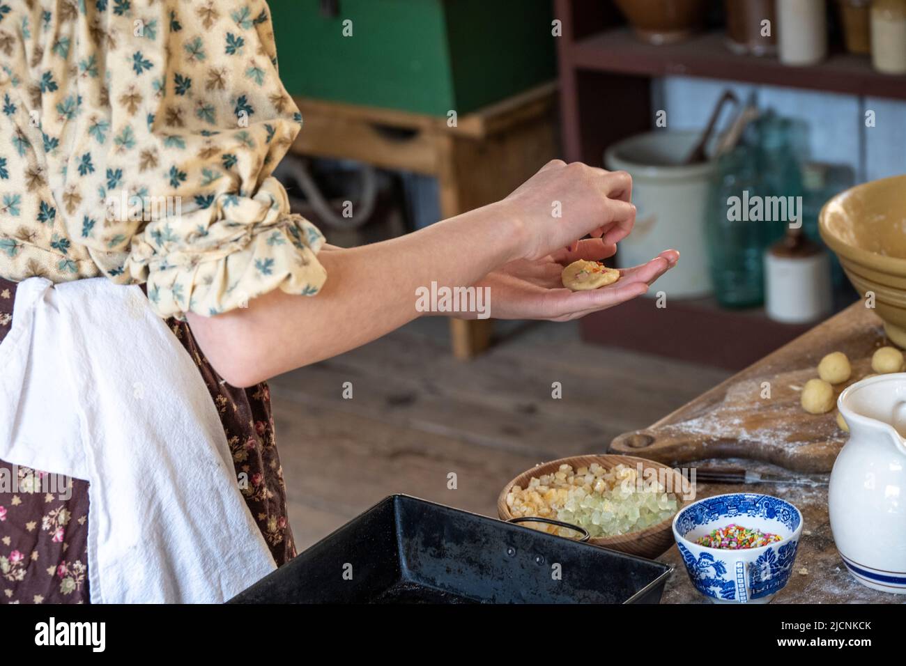 making cookies with candy fruit as a topping at the historic Fort Nisqually Living Museum in Tacoma, Washington Stock Photo