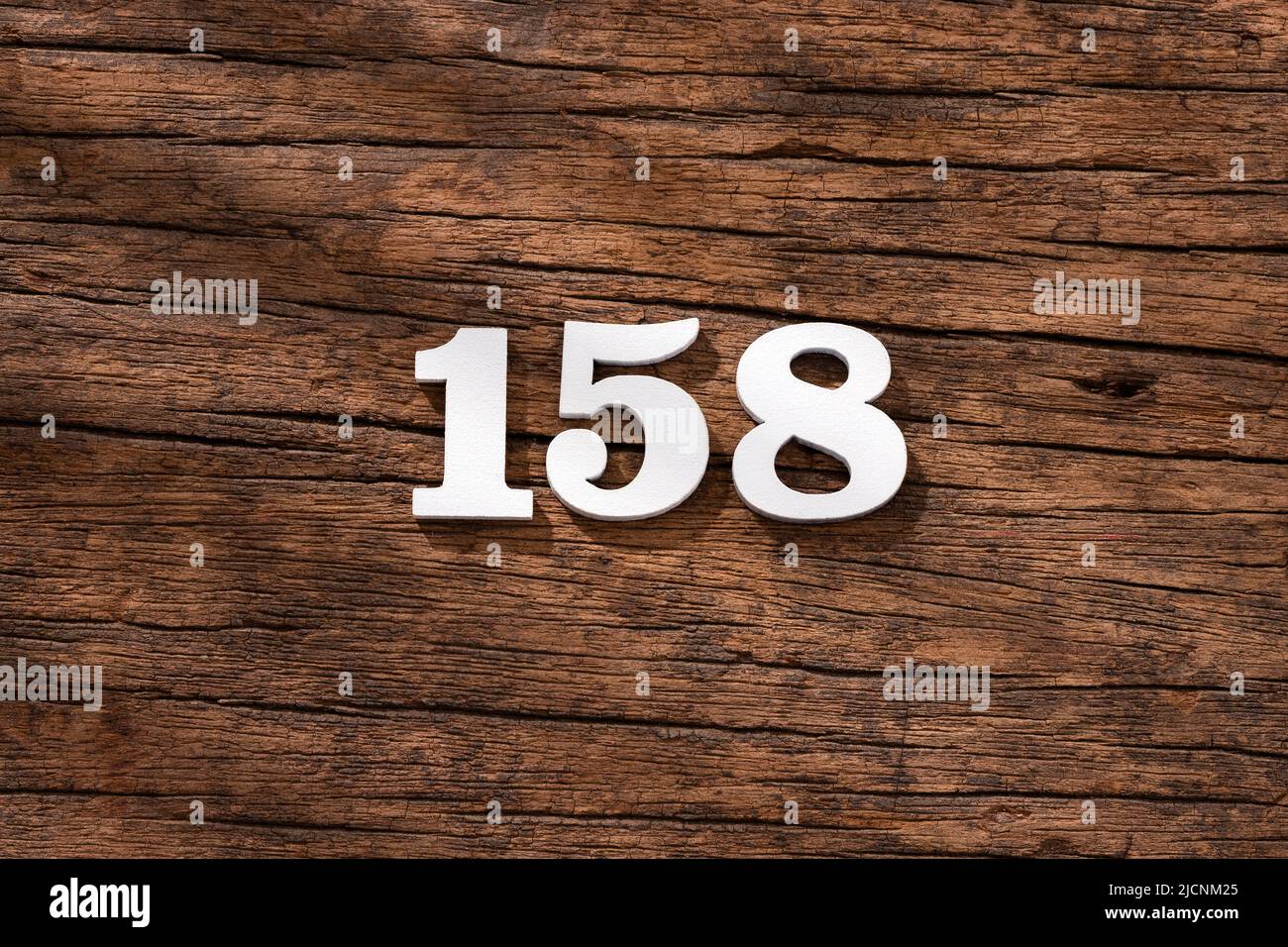 Number 158 in wood, isolated on rustic background Stock Photo