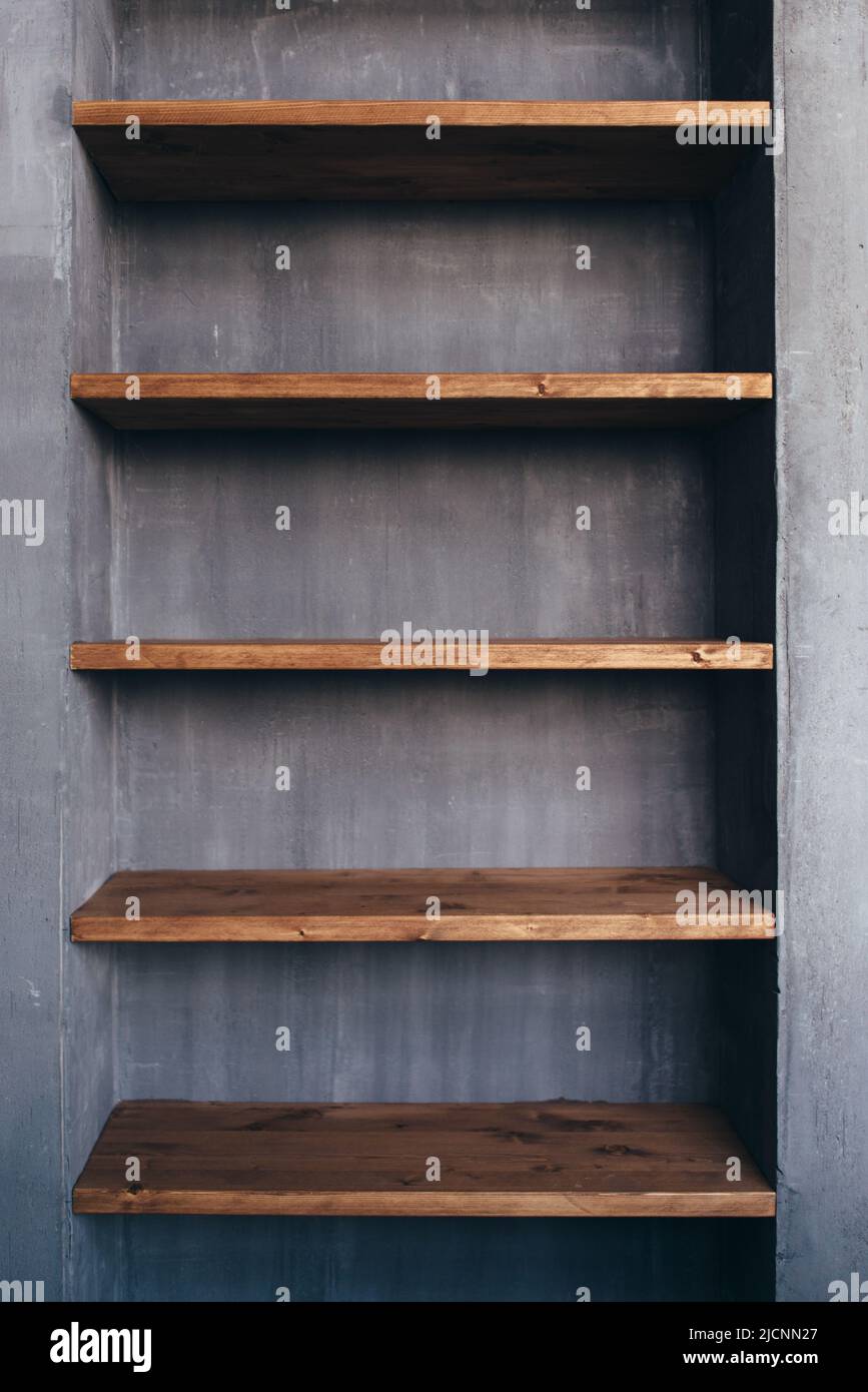 Empty wood shelves at concrete wall in home interior Stock Photo Alamy