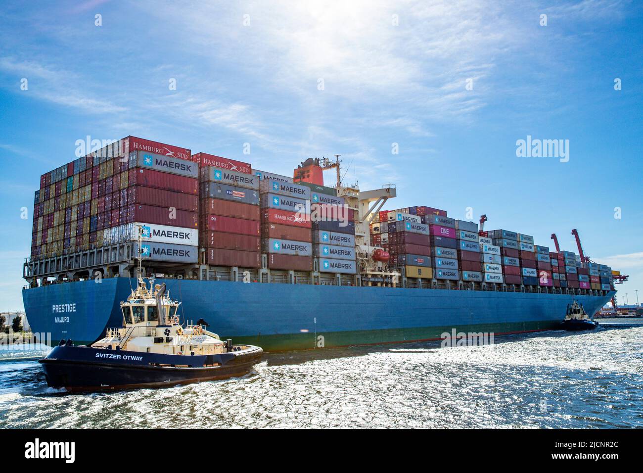 Tug with line to cargo ship with containers in Melbourne, Victoria, Australia on Sunday, April 17, 2022.Photo: David Rowland / One-Image.com Stock Photo
