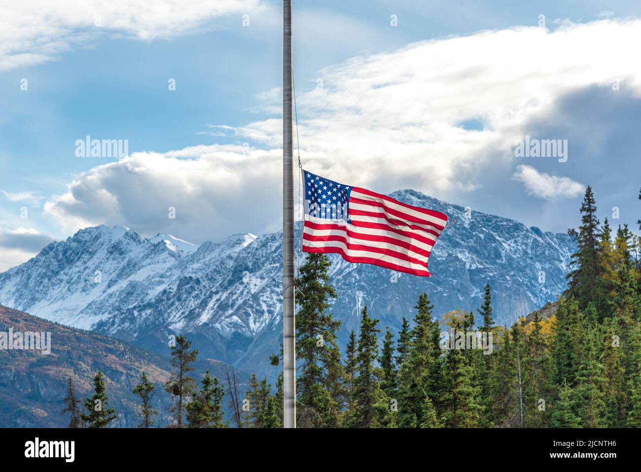 USA, United States stars & stripes flag seen flying half mast on a flag pole near Alaska during