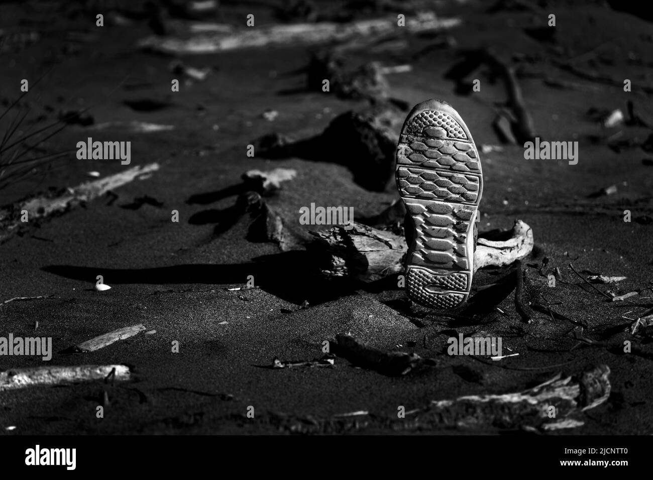 A mysterious left shoe with a white sole washed up on a beach, Aotearoa / New Zealand Stock Photo