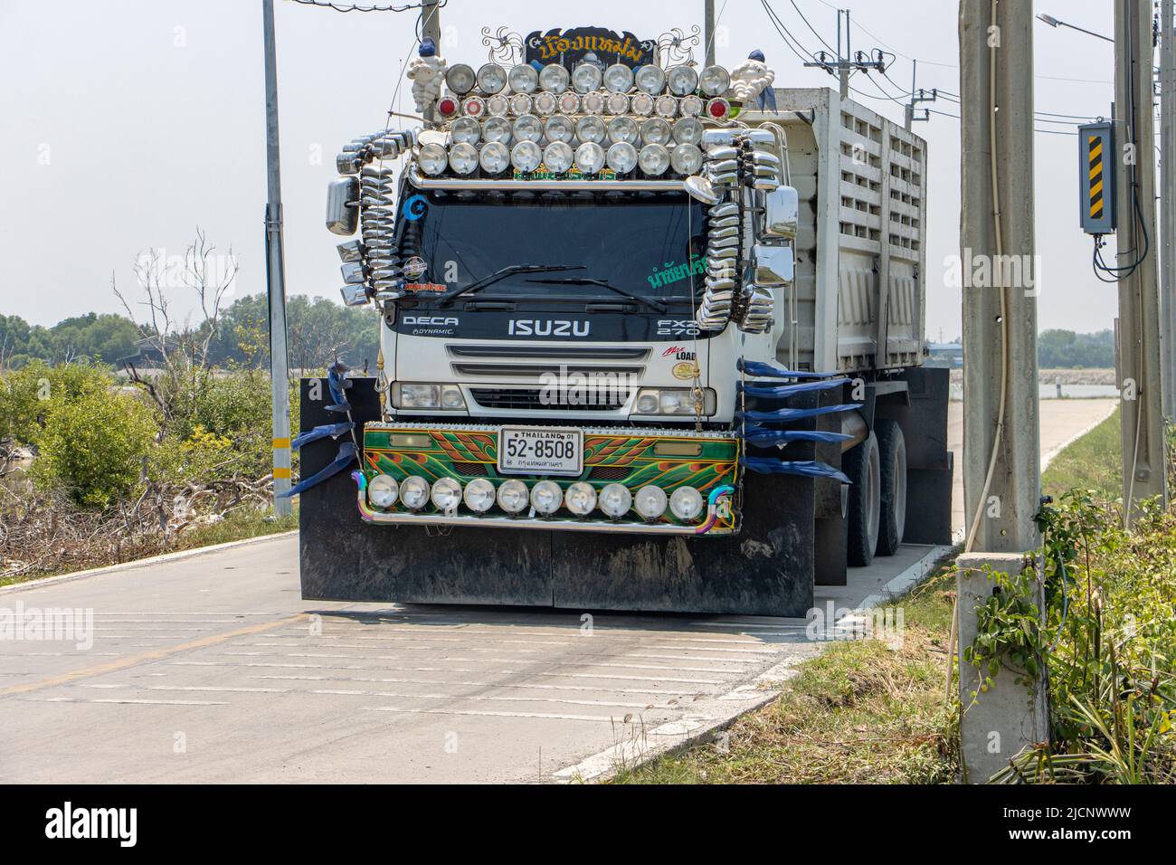 SAMUT PRAKAN, THAILAND, APR 14 2022, A painted trucks drives on the rural road, front view Stock Photo