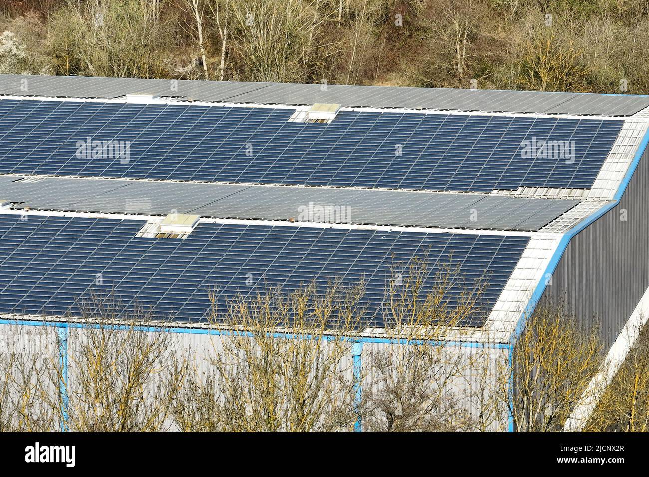Aerial view of blue photovoltaic solar panels mounted on industrial ...