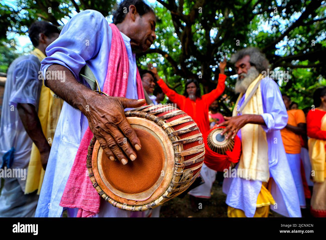 Guptipara, India. 14th June, 2022. Hindu devotees seen playing drums and different musical instruments at Brindaban Chandra Temple during the Snanyatra Festival of Lord Jagannath. A special bath of Lord Jagannath takes place on the Purnima of Jyestha month (Devasnan Purnima), to commemorate the appearance day of Lord Jagannath. According to Skanda Purana when Raja Indradyumna installed the wooden deities he arranged this bathing ceremony. This day is considered to be the birthday of Lord jagannath. Credit: SOPA Images Limited/Alamy Live News Stock Photo