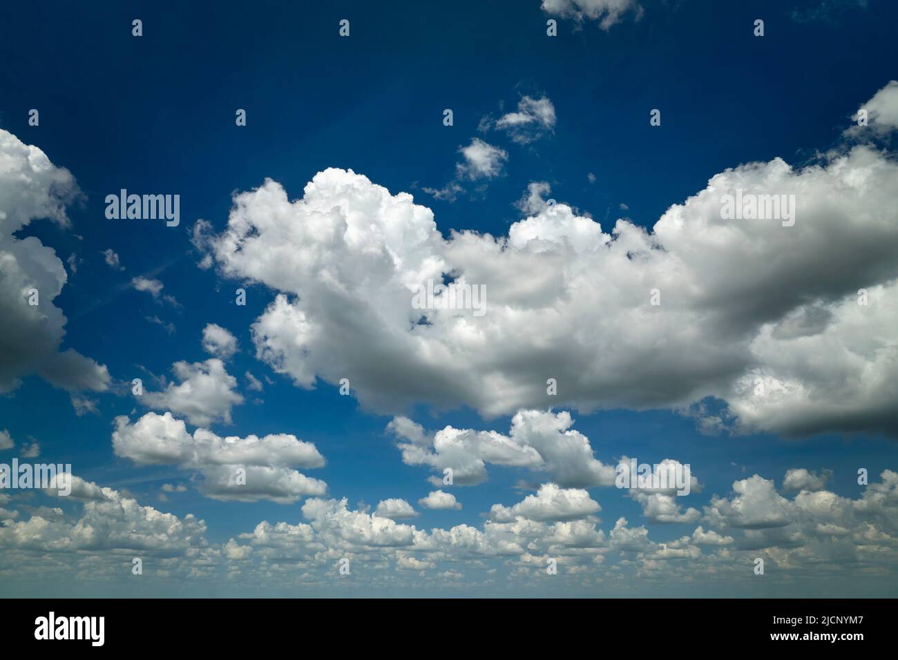 White puffy cumulus clouds on summer blue sky Stock Photo - Alamy