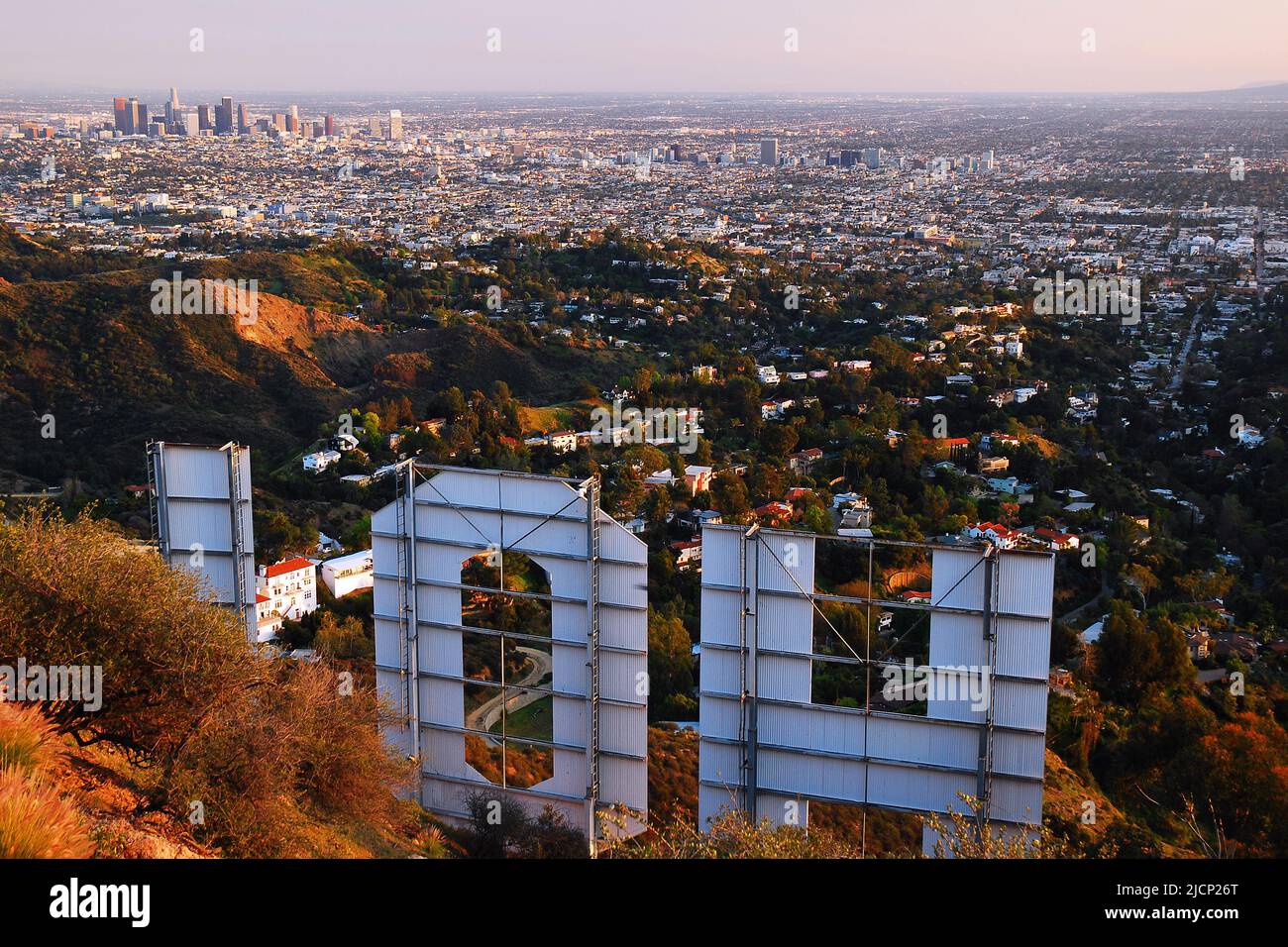 The Hollywood sign, a symbol of the movie, film and entertainment industry rises over the city of Los Angeles Stock Photo