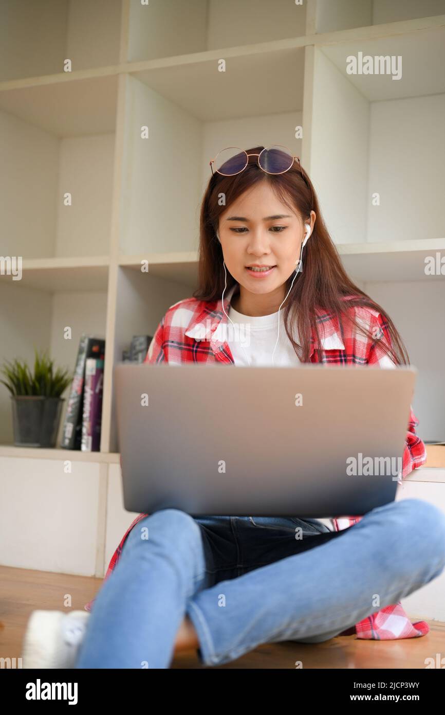 Portrait of an attractive young asian female university student sitting ...