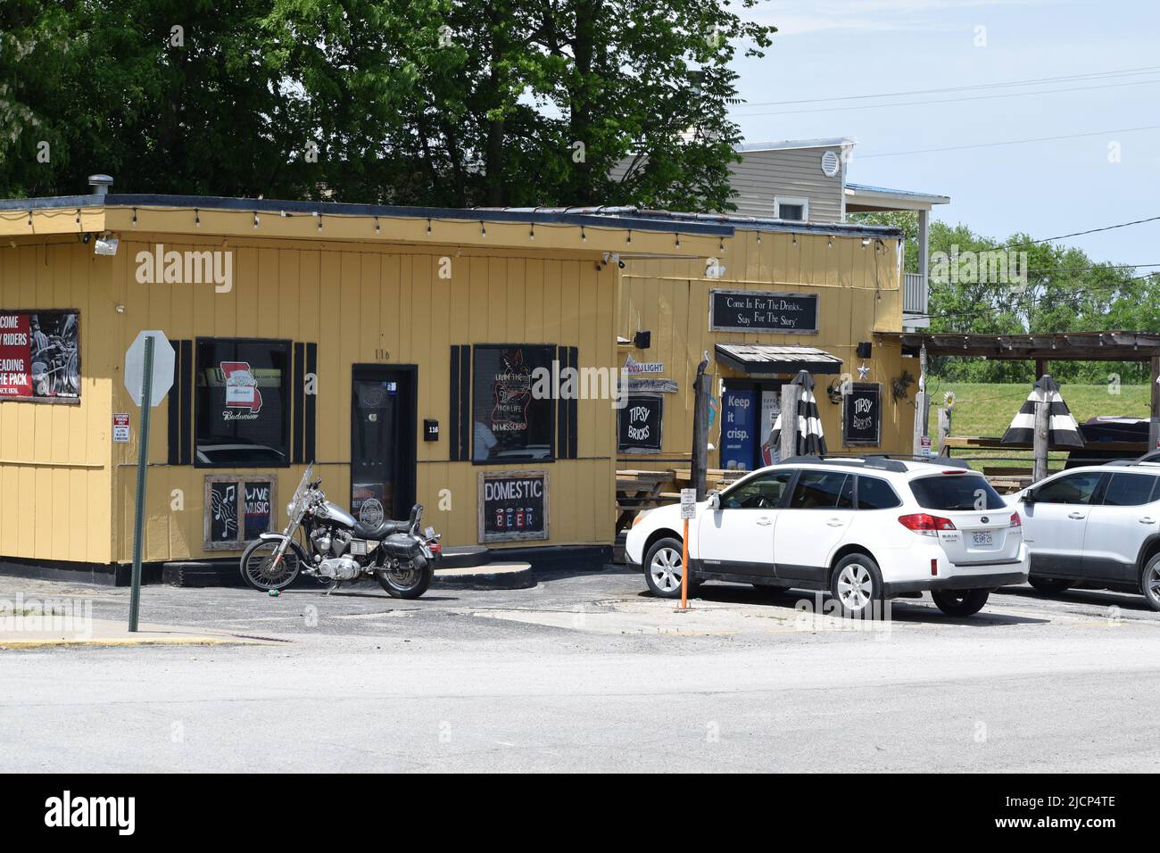 Cars and a motorcycle parked outside the Tipsy Bricks bar in downtown