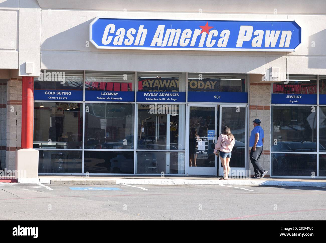 A man and a woman walking into a Cash America Pawn shop Stock Photo