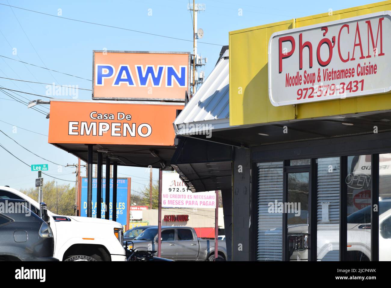 Signs for a Pho Cam Vietnamese restaurant, a pawn shop and Casa De Empeno in Irving, Texas Stock Photo