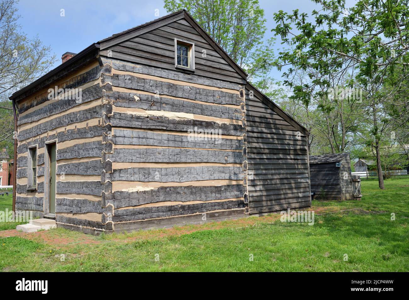Nauvoo, Illinois, USA. A log cabin or home part of the local historical site. The well maintained structure is part of the Nauvoo Historic District. Stock Photo