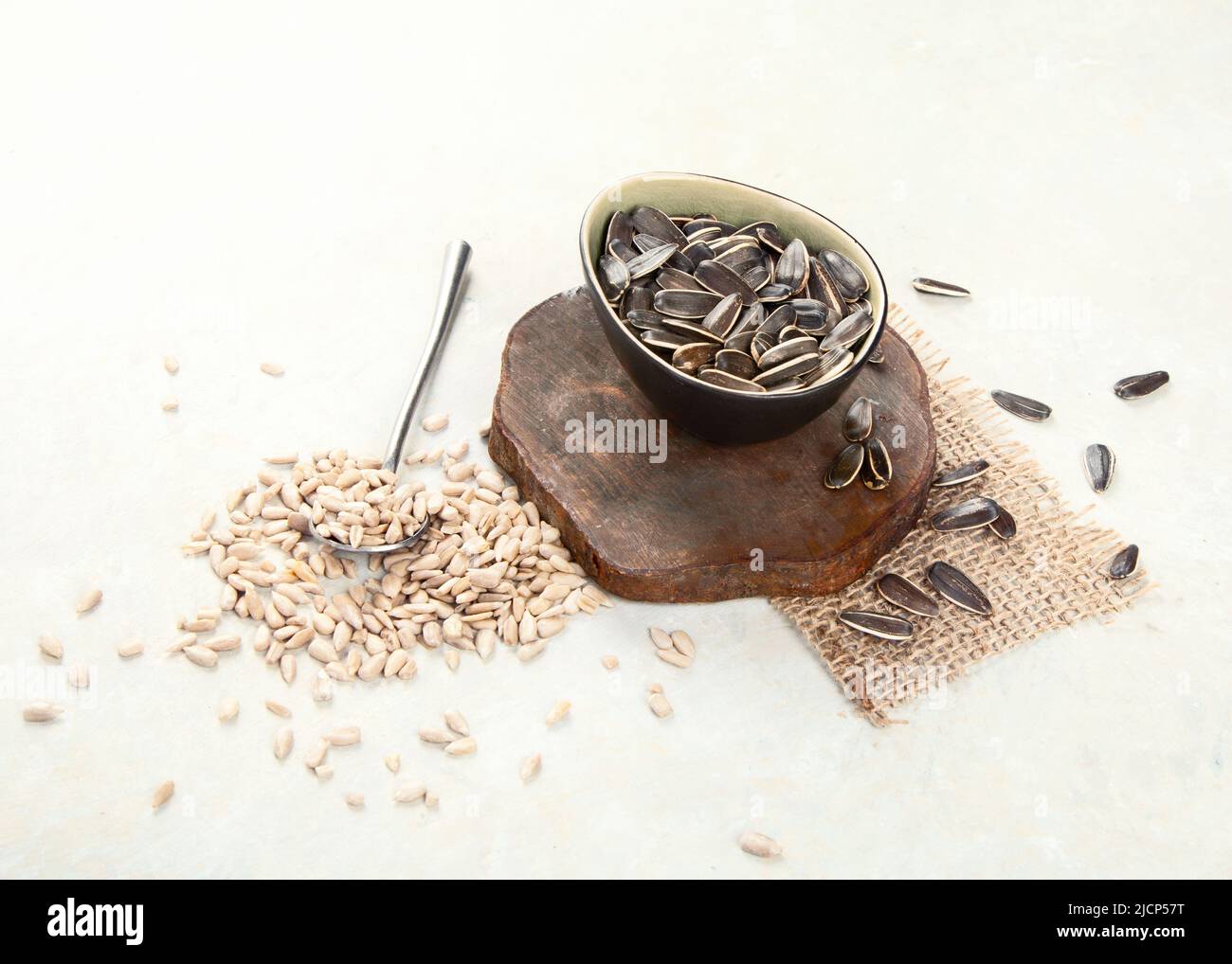 Sunflower oil and sunflower seeds on light background. Organic concept. Healthy food and fats