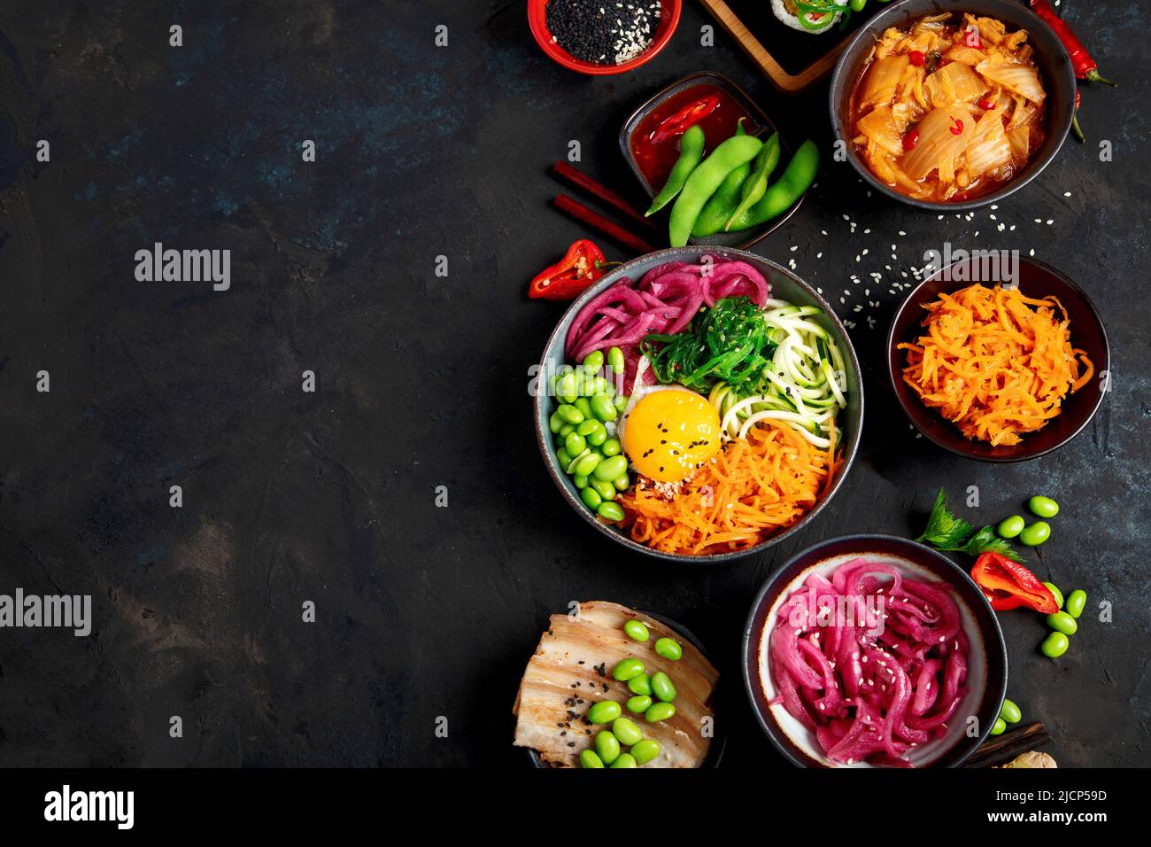 Assortment of Korean food on dark background. Asian dishes and appetizers of indeed cuisine. Top view, flat lay, copy space Stock Photo