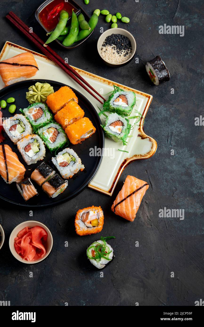 Sushi assortment on dark background. Japanese traditional luxury meal. Top view, flat lay, copy space Stock Photo