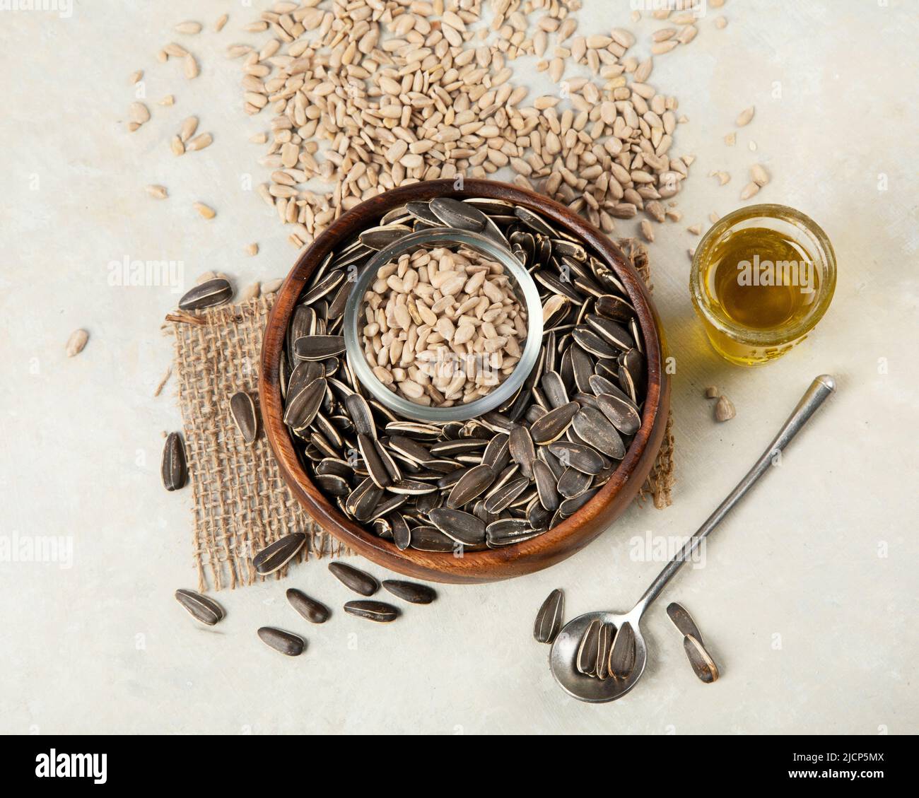 Sunflower oil and sunflower seeds on light background. Organic concept. Healthy food and fats. Top view, flat lay Stock Photo