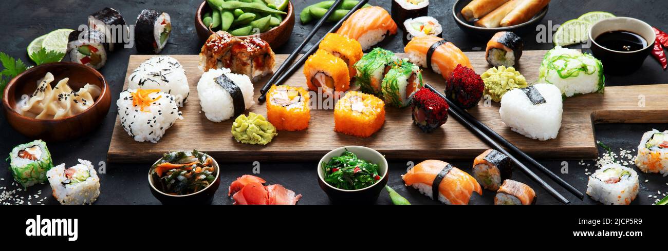 Japanese food assortment on dark background. Traditional food concept. Dishes and appetizers of indeed cuisine. panorama Stock Photo